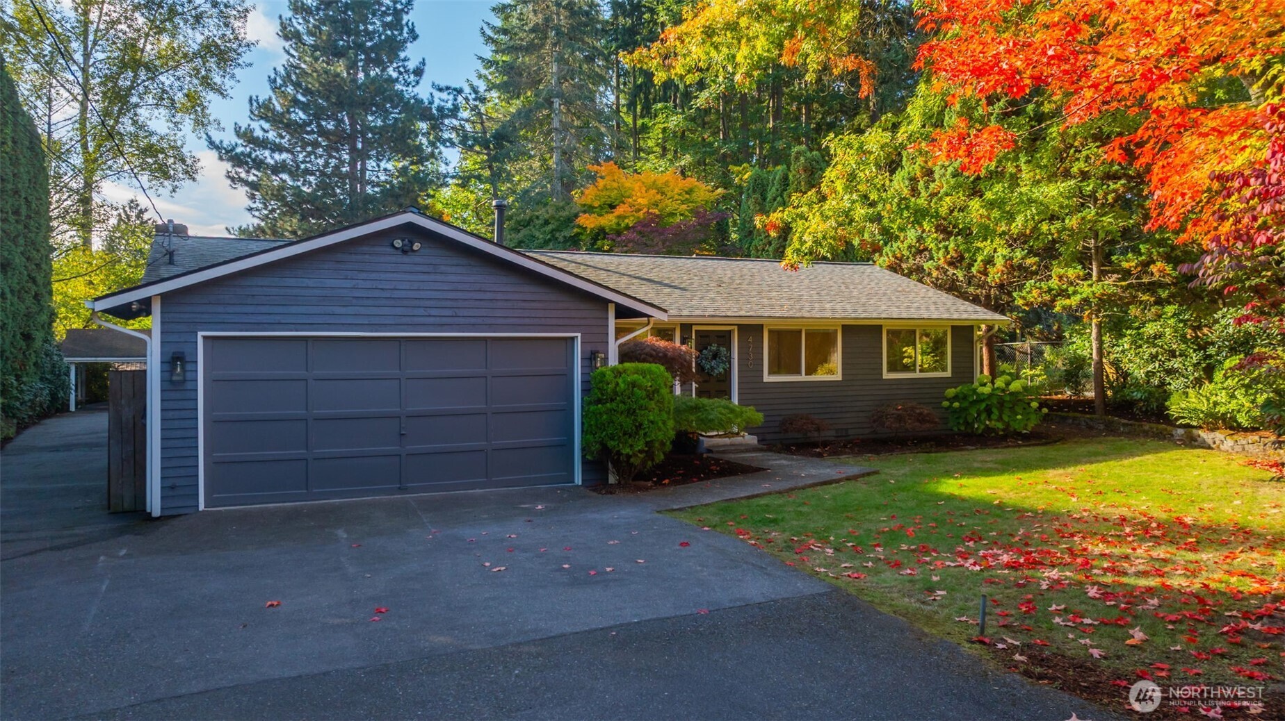 4730 228th Street Southeast Bothell, WA 98021 - Photo 2 of 37 a front view of a house with a yard and garage