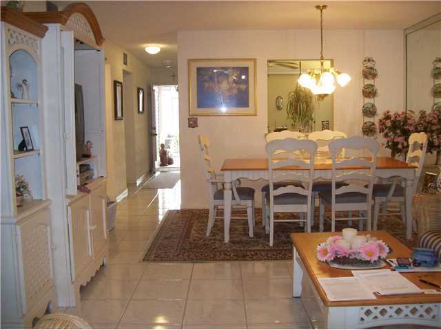 18761 Garbo Terrace, Unit 7 Boca Raton, FL 33496 - Photo 3 of 11 a dining room with furniture a chandelier and kitchen view