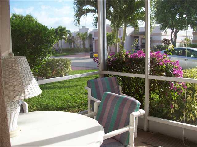 18761 Garbo Terrace, Unit 7 Boca Raton, FL 33496 - Photo 7 of 11 a view of a chairs and table in patio with a yard