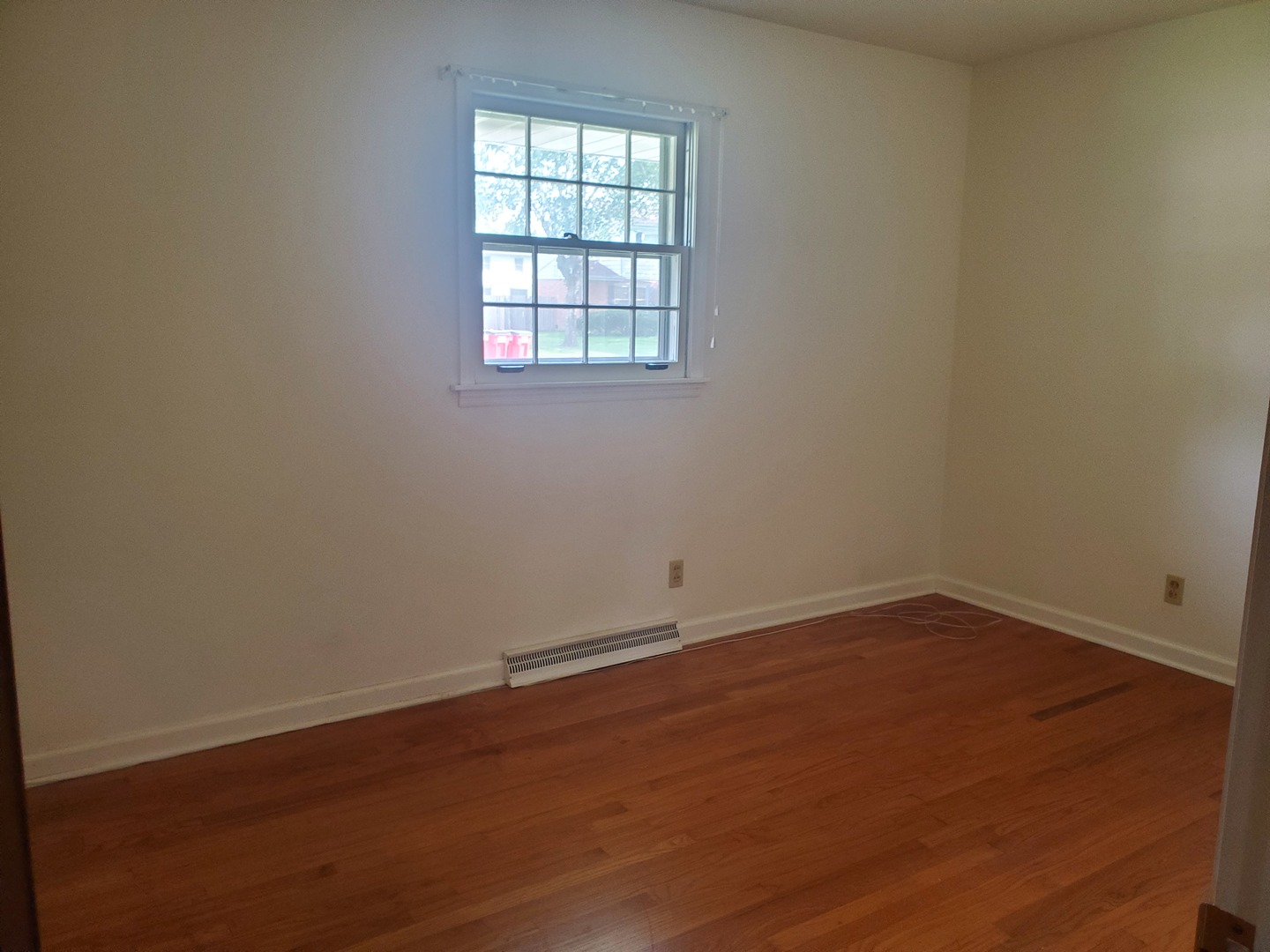 1910 Robert Drive Champaign, IL 61821 - Photo 8 of 10 an empty room with wooden floor and windows