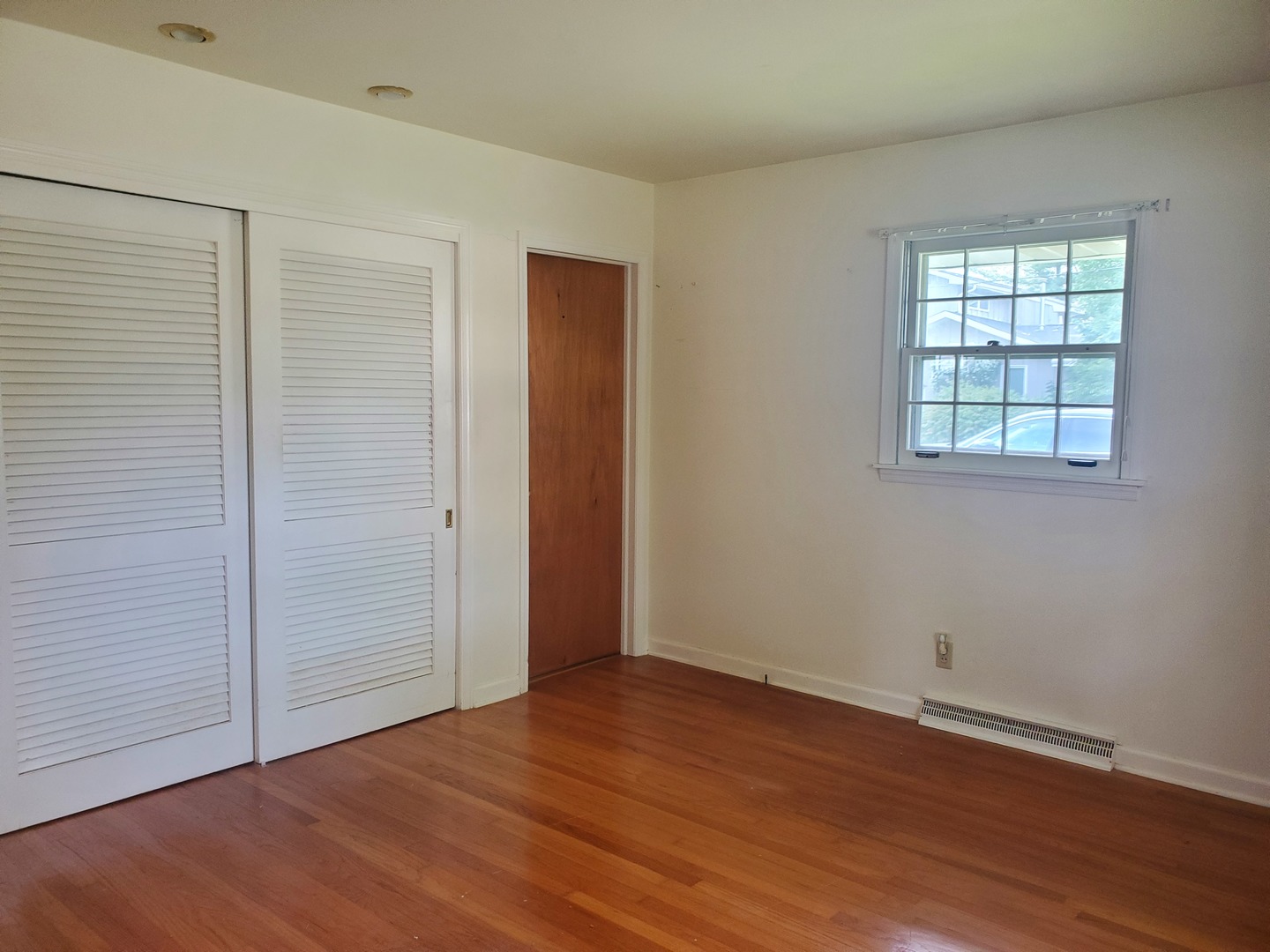 1910 Robert Drive Champaign, IL 61821 - Photo 9 of 10 an empty room with wooden floor and windows