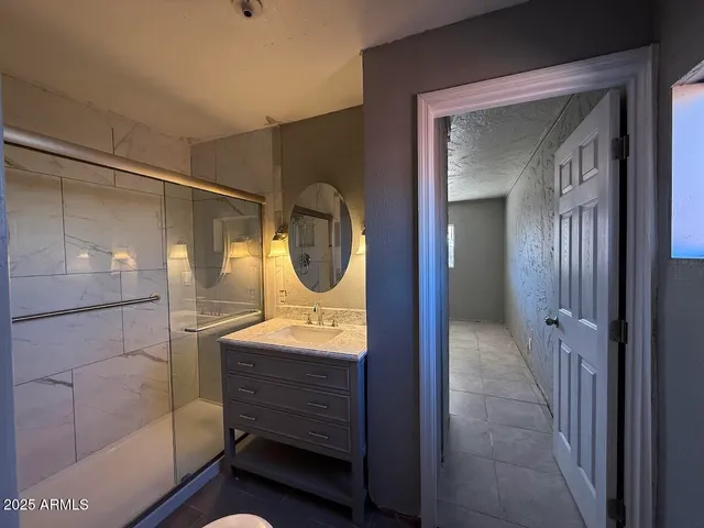 a bathroom with a mirror and a shower