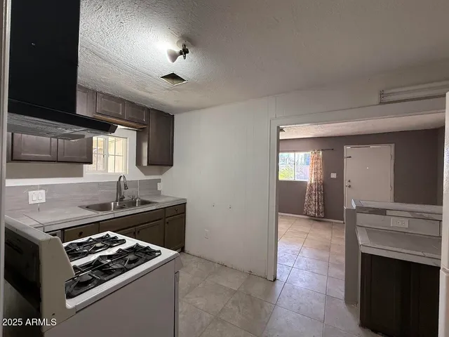 a kitchen with stainless steel appliances granite countertop a stove and a sink
