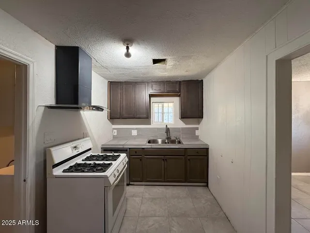 a kitchen that has a sink and a stove in it