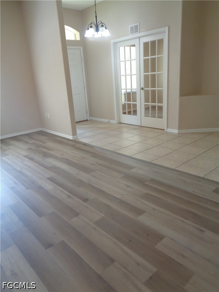 2463 Nature Pointe Loop Fort Myers, FL 33905 - Photo 6 of 50 an empty room with wooden floor and windows