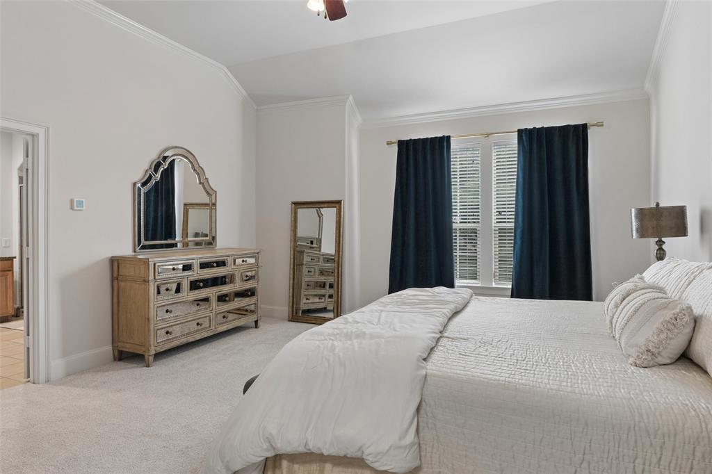 1600 Abrams Road, Unit 22 Dallas, TX 75214 - Photo 17 of 38 a bedroom with a bed and dresser with mirror