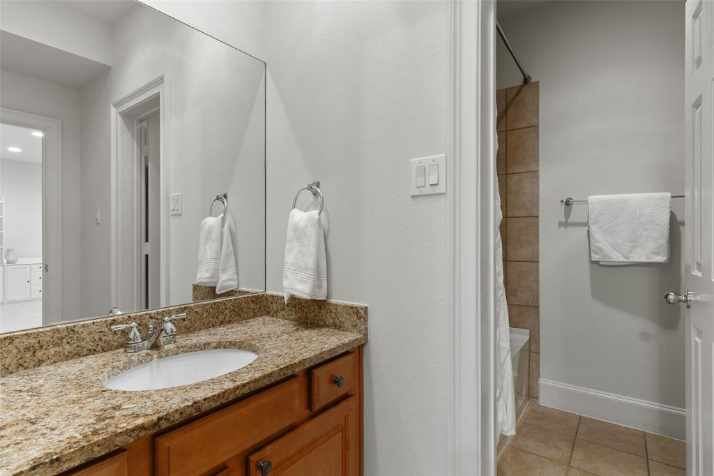 1600 Abrams Road, Unit 22 Dallas, TX 75214 - Photo 27 of 38 a bathroom with a granite countertop sink and a mirror
