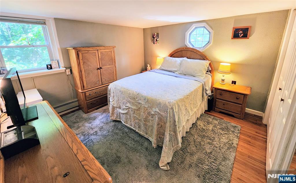 274 Franklin Turnpike, Unit GARAGE APART Ridgewood, NJ 07450 - Photo 6 of 11 a bedroom with a bed dresser and a window