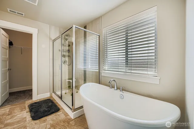 a bathroom with a bathtub and a shower