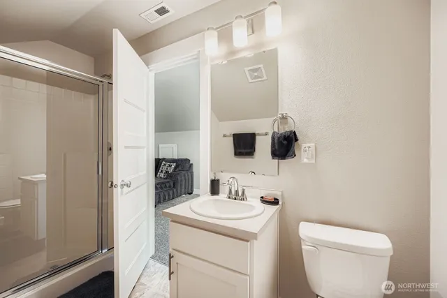 a bathroom with a toilet sink and mirror