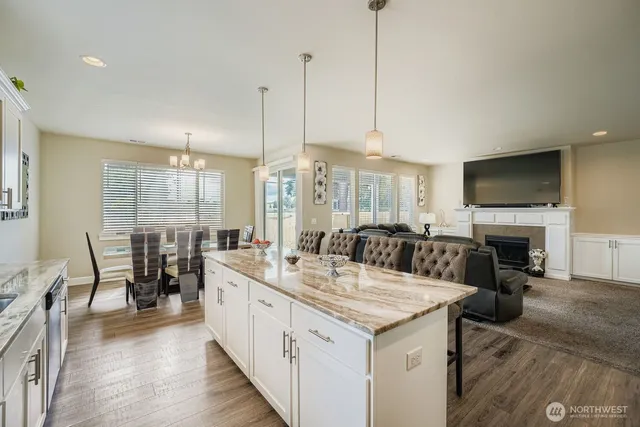a large kitchen with cabinets table and chairs