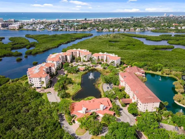 an aerial view of a house with a garden and lake view