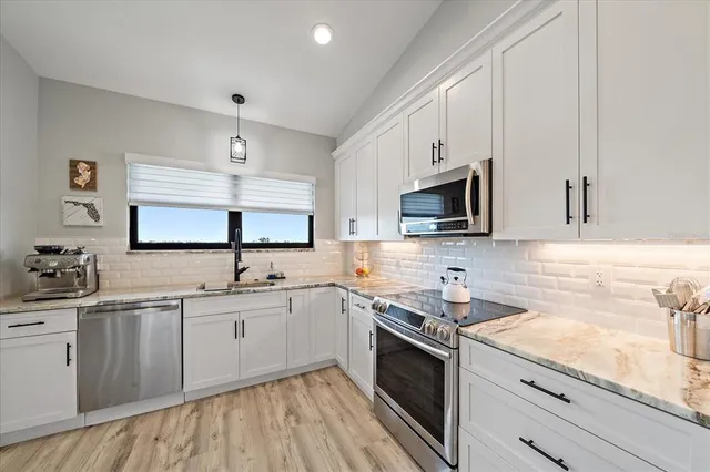 a kitchen with a sink stove and microwave
