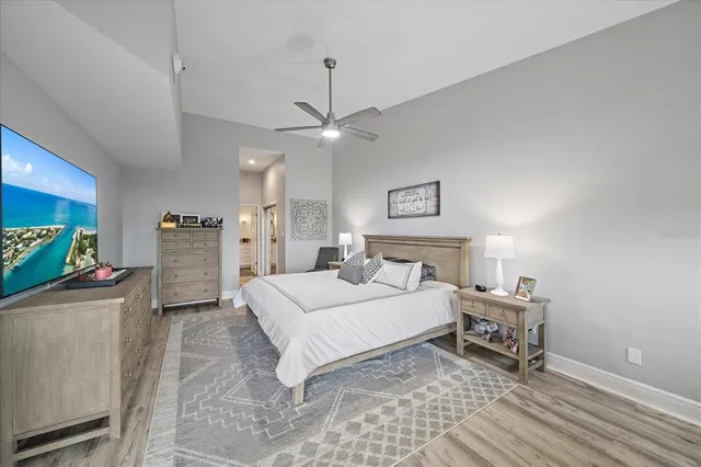 a spacious bedroom with a bed and a chandelier