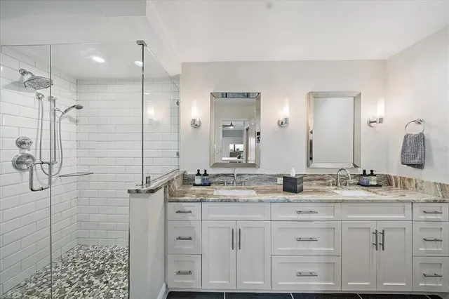 a bathroom with a granite countertop sink mirror and double
