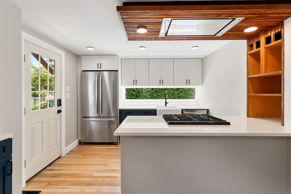 10 Wolcott Street Wakefield, MA 01880 - Photo 12 of 42 a kitchen with stainless steel appliances a refrigerator and a stove