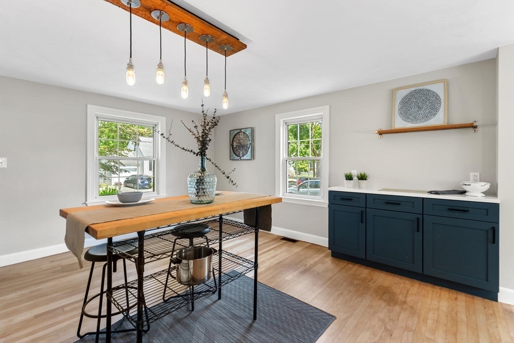 10 Wolcott Street Wakefield, MA 01880 - Photo 13 of 42 a dining room with a table chairs and chandelier