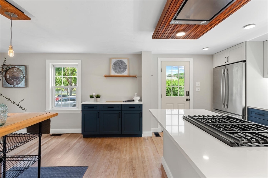 10 Wolcott Street Wakefield, MA 01880 - Photo 14 of 42 a kitchen with sink a window and stainless steel appliances