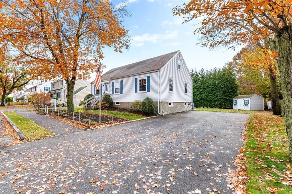 10 Wolcott Street Wakefield, MA 01880 - Photo 5 of 42 a view of a house with a yard and large trees