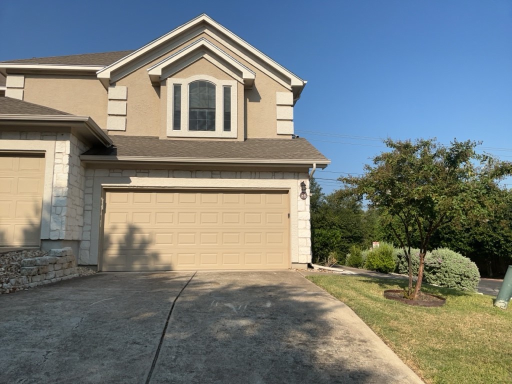 3300 Forest Creek Drive, Unit 26 Round Rock, TX 78664 - Photo 1 of 21 a front view of a house with a yard and garage