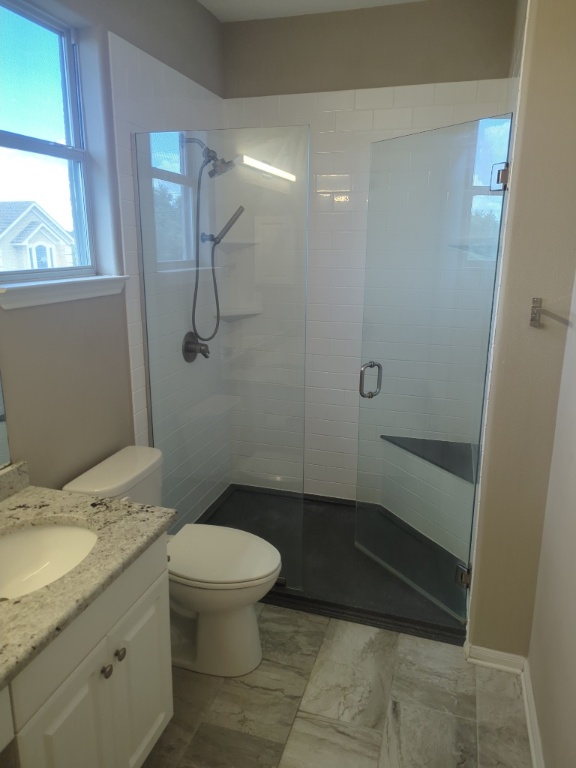 3300 Forest Creek Drive, Unit 26 Round Rock, TX 78664 - Photo 11 of 21 a bathroom with a granite countertop sink a toilet and shower