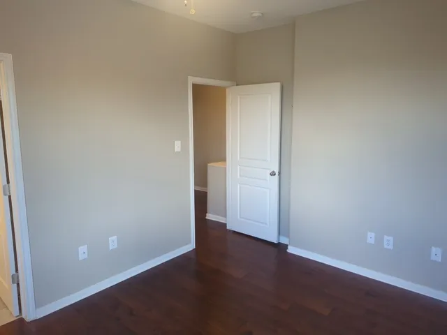 an empty room with wooden floor and closet