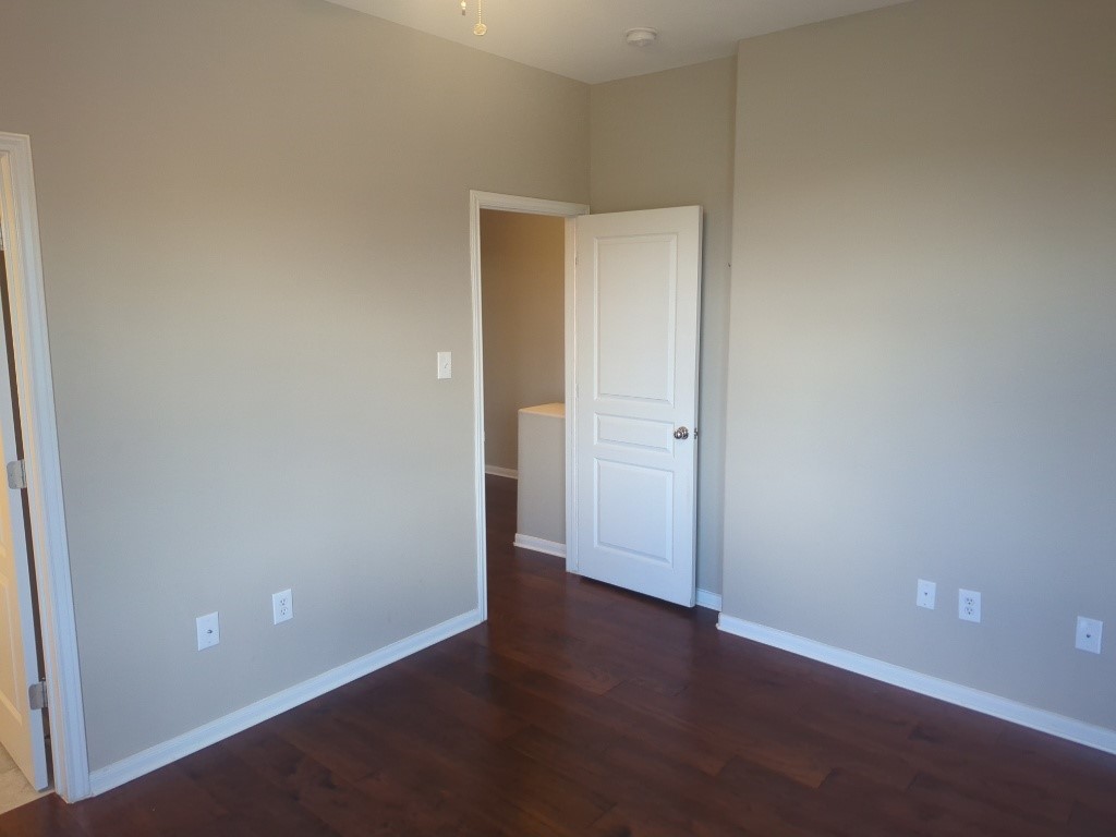 3300 Forest Creek Drive, Unit 26 Round Rock, TX 78664 - Photo 13 of 21 an empty room with wooden floor and closet