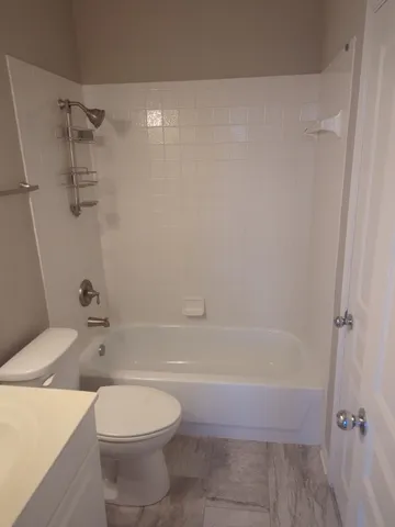 a bathroom with a toilet and a bath tub