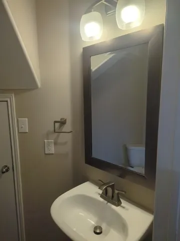 a bathroom with a sink and mirror