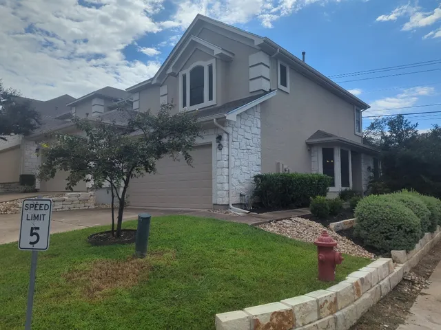 a view of a house with a yard and sitting area