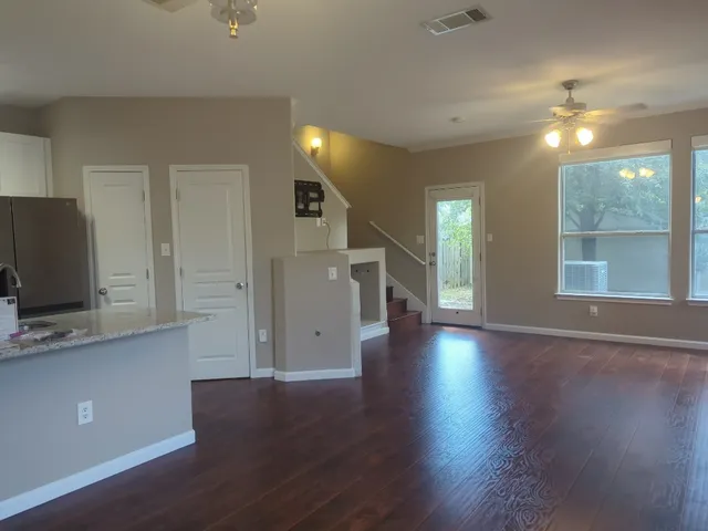 a view of a livingroom with wooden floor and a window