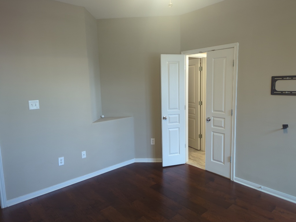 3300 Forest Creek Drive, Unit 26 Round Rock, TX 78664 - Photo 9 of 21 an empty room with wooden floor and windows