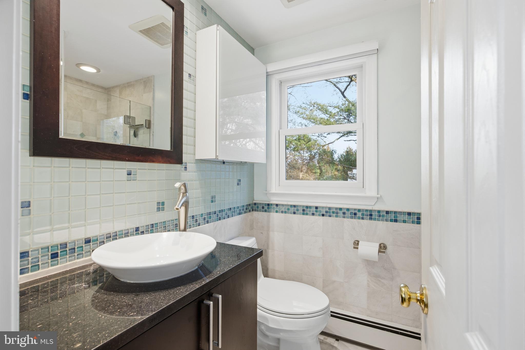 460 Rocksville Road Southampton, PA 18966 - Photo 20 of 59 a bathroom with a granite countertop toilet a sink and a mirror