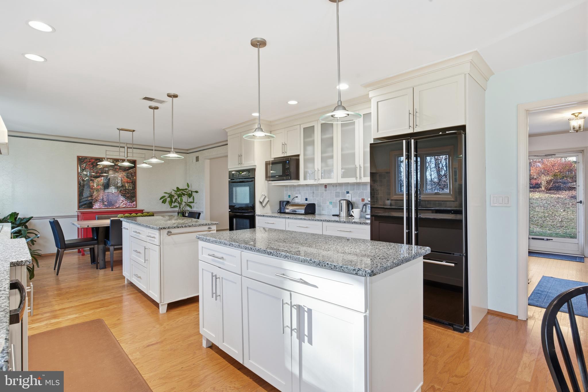 460 Rocksville Road Southampton, PA 18966 - Photo 3 of 59 a kitchen with stainless steel appliances granite countertop a refrigerator a sink dishwasher a stove and white cabinets with wooden floor