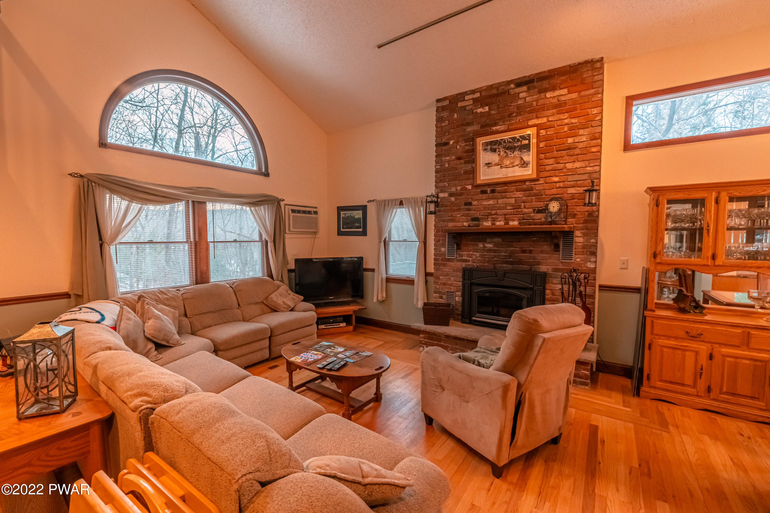 4141 Winchester Way Bushkill, PA 18324 - Photo 8 of 75 a living room with furniture a fireplace and a large window