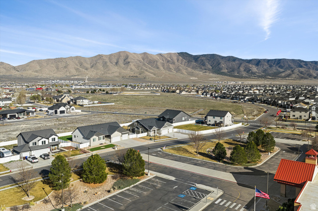 3938 North Wood Road Eagle Mountain, UT 84005 - Photo 49 of 55 Aerial view of residential area featuring a mountainous background
