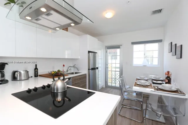 a kitchen with a table and chairs