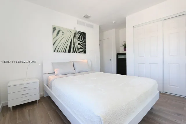 a bedroom with a bed and a night stand