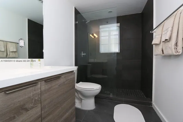 a bathroom with a sink toilet and a mirror