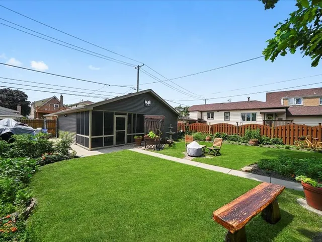 a front view of a house with a yard table and chairs