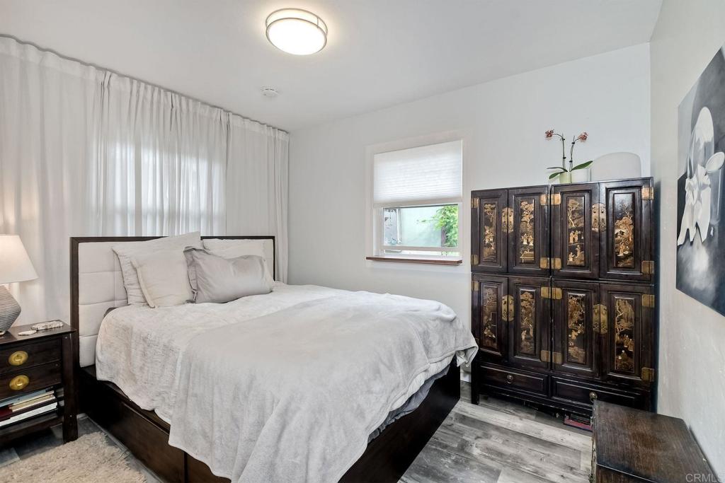 476 La Veta Avenue Encinitas, CA 92024 - Photo 11 of 24 a bedroom with a bed a mirror and windows
