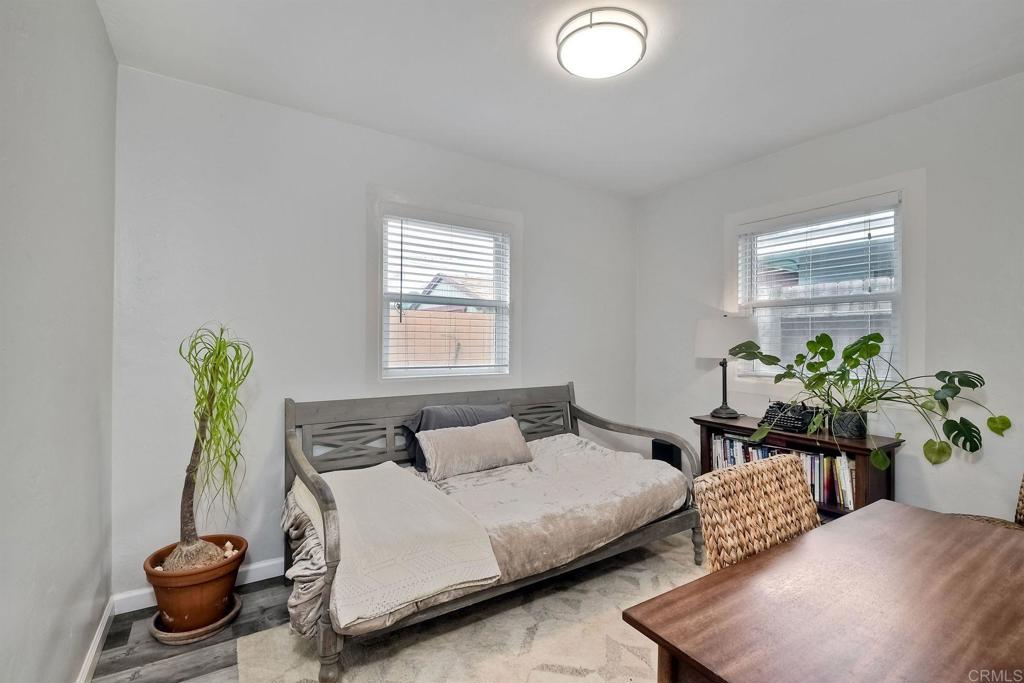 476 La Veta Avenue Encinitas, CA 92024 - Photo 13 of 24 a bedroom with a bed potted plant and a window