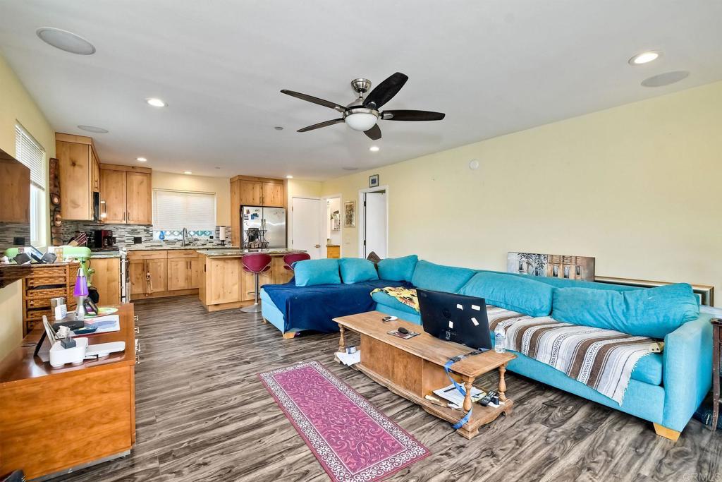 476 La Veta Avenue Encinitas, CA 92024 - Photo 15 of 24 a living room with furniture kitchen view and a wooden floor
