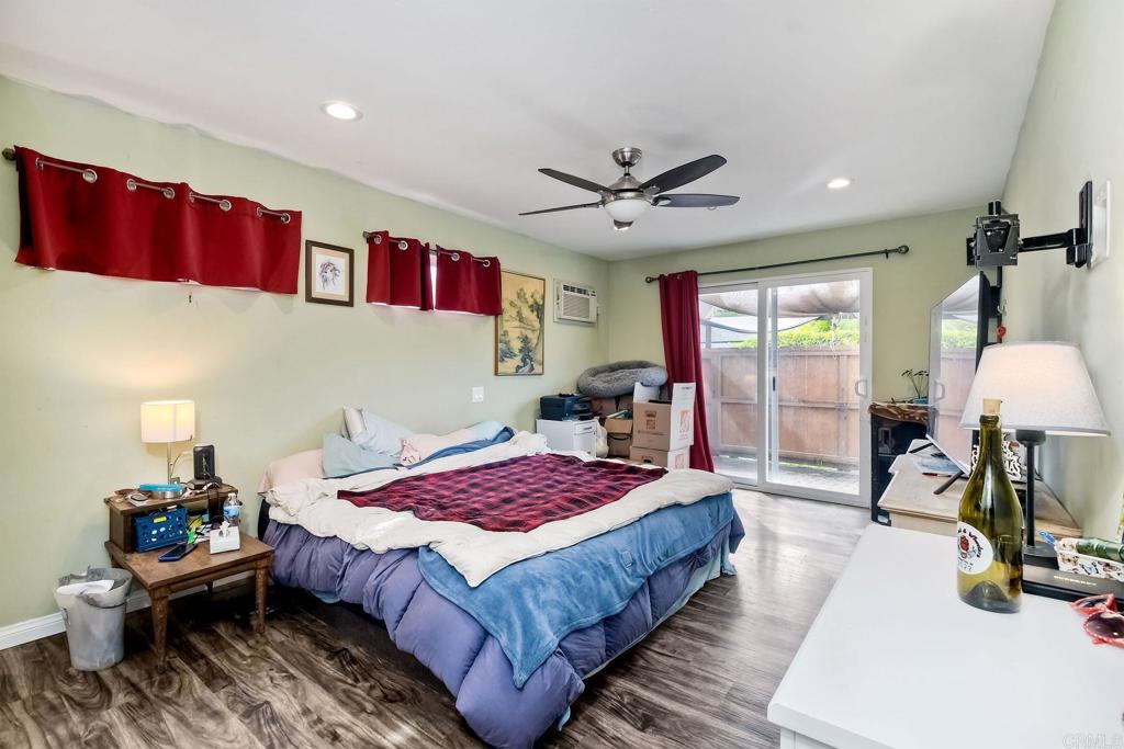 476 La Veta Avenue Encinitas, CA 92024 - Photo 20 of 24 a spacious bedroom with a bed a table and potted plant with the dresser