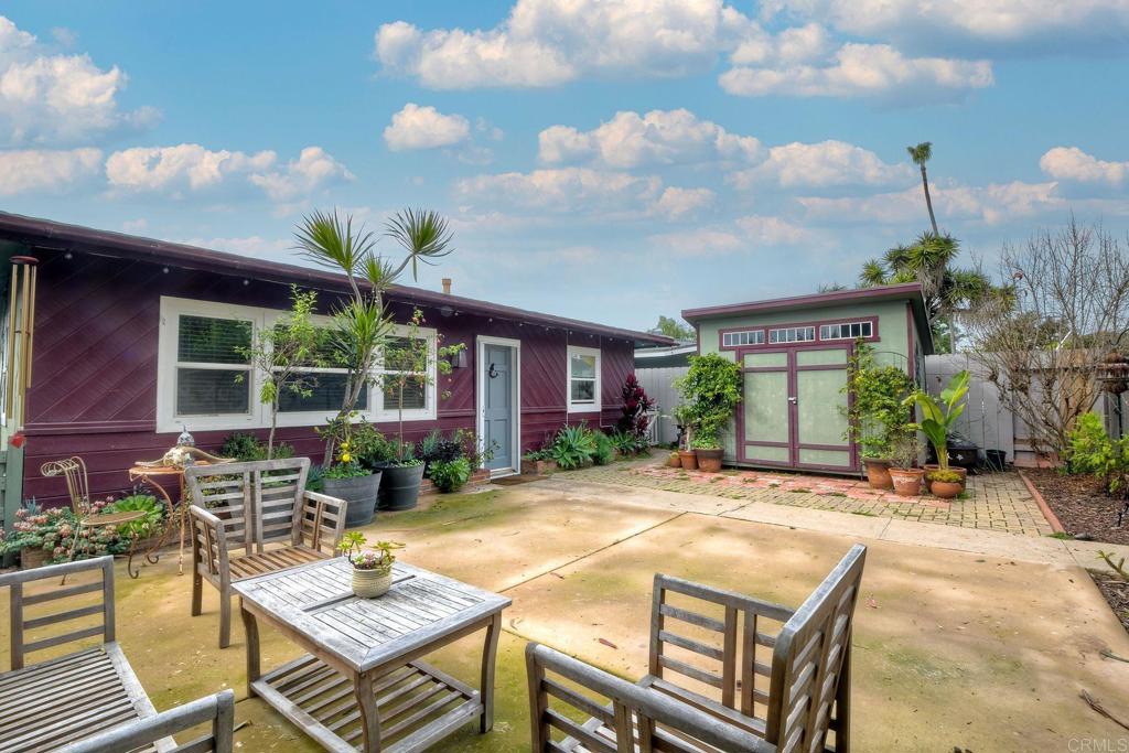476 La Veta Avenue Encinitas, CA 92024 - Photo 4 of 24 a view of a dinning table and chairs in patio of the house