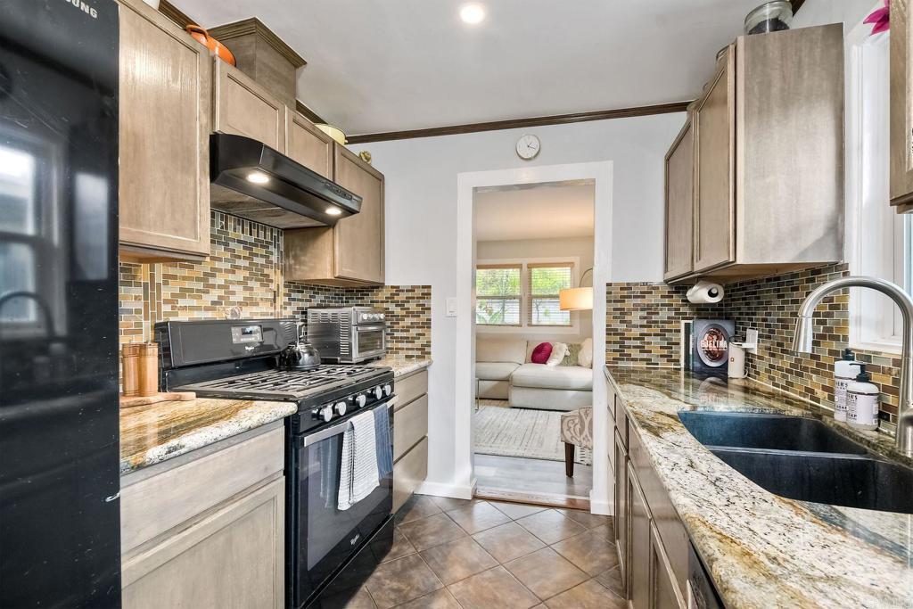 476 La Veta Avenue Encinitas, CA 92024 - Photo 9 of 24 a kitchen with stainless steel appliances granite countertop a sink stove and refrigerator