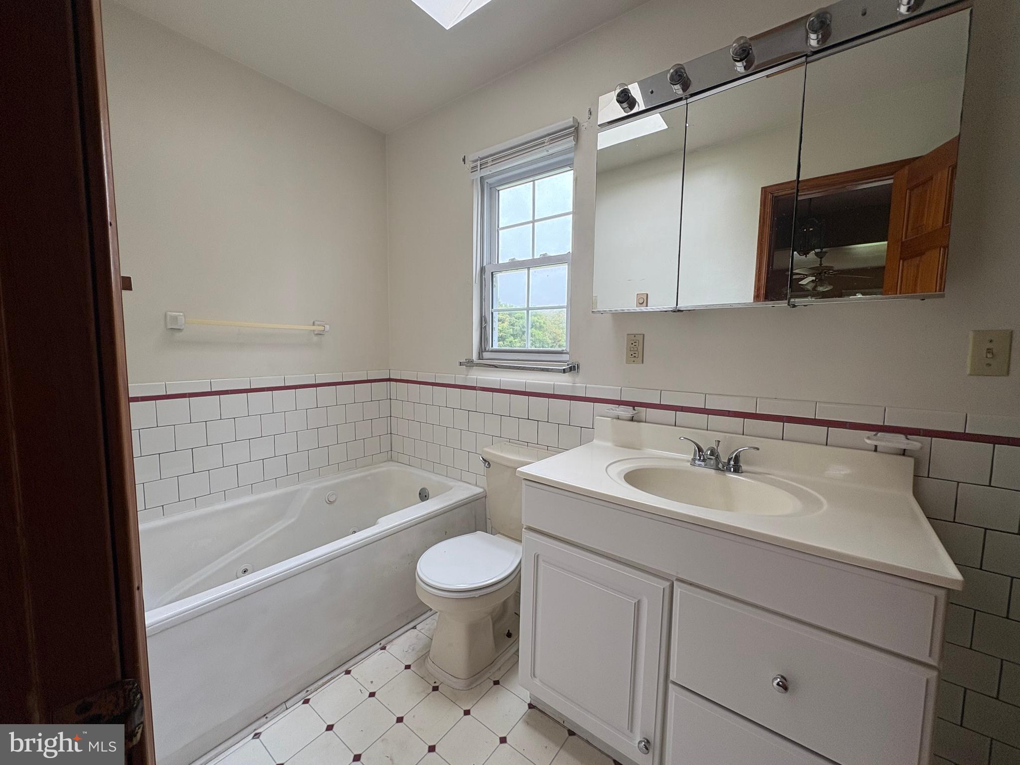 6525 Nomini Hall Road Hague, VA 22469 - Photo 15 of 44 a bathroom with a sink a toilet a mirror and bathtub