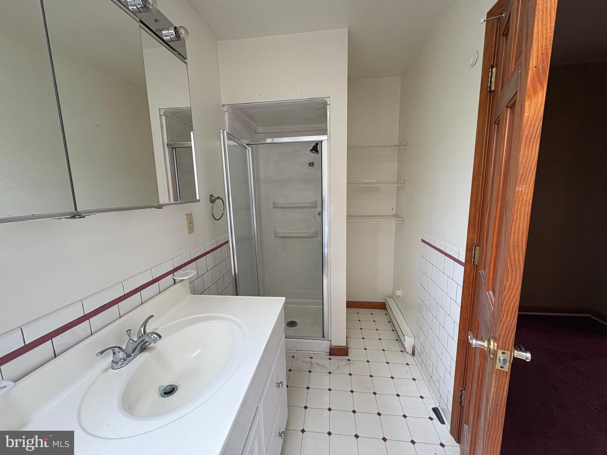 6525 Nomini Hall Road Hague, VA 22469 - Photo 16 of 44 a bathroom with a sink a toilet a shower and a mirror