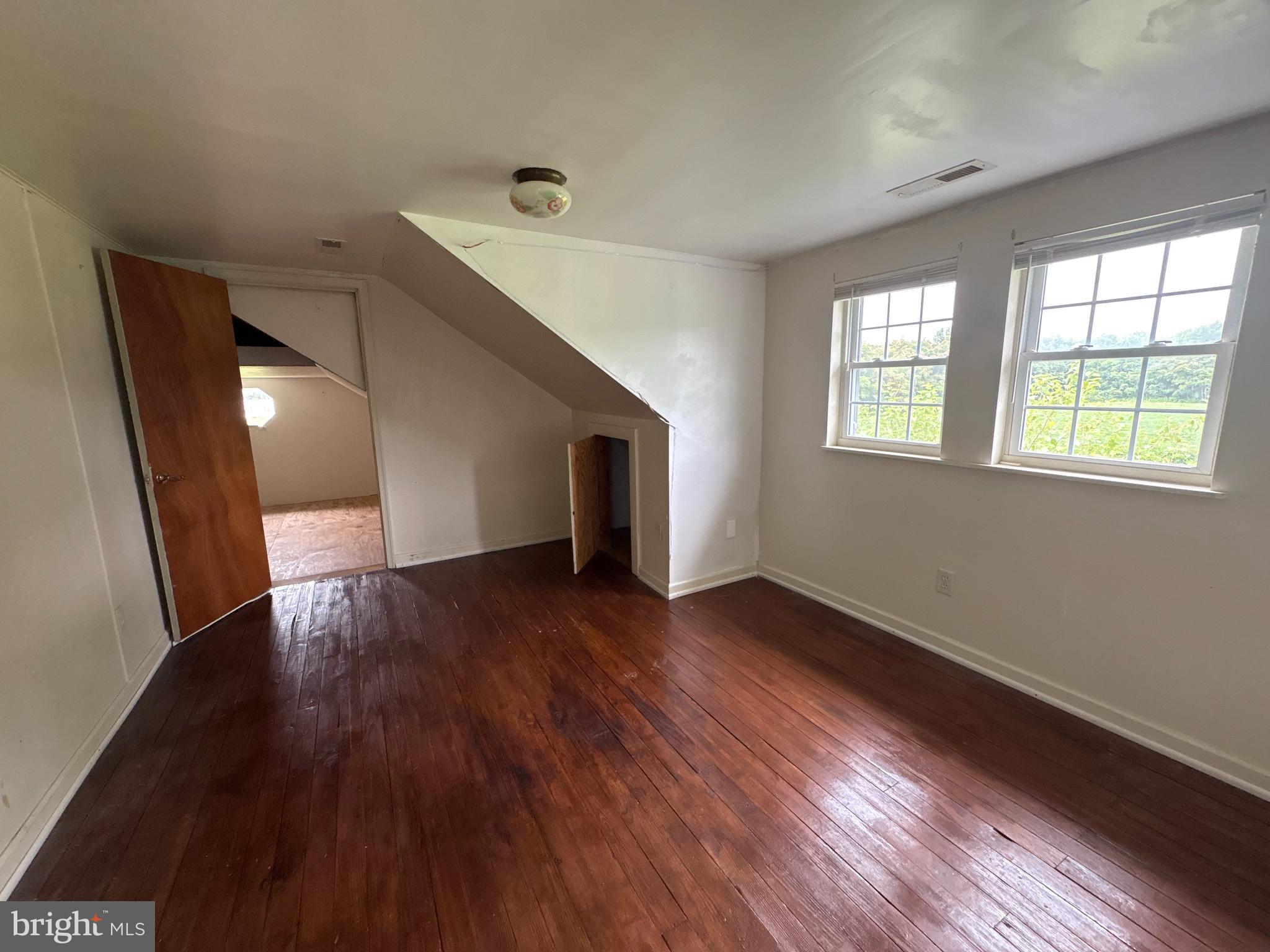 6525 Nomini Hall Road Hague, VA 22469 - Photo 26 of 44 a view of an empty room with wooden floor and a window