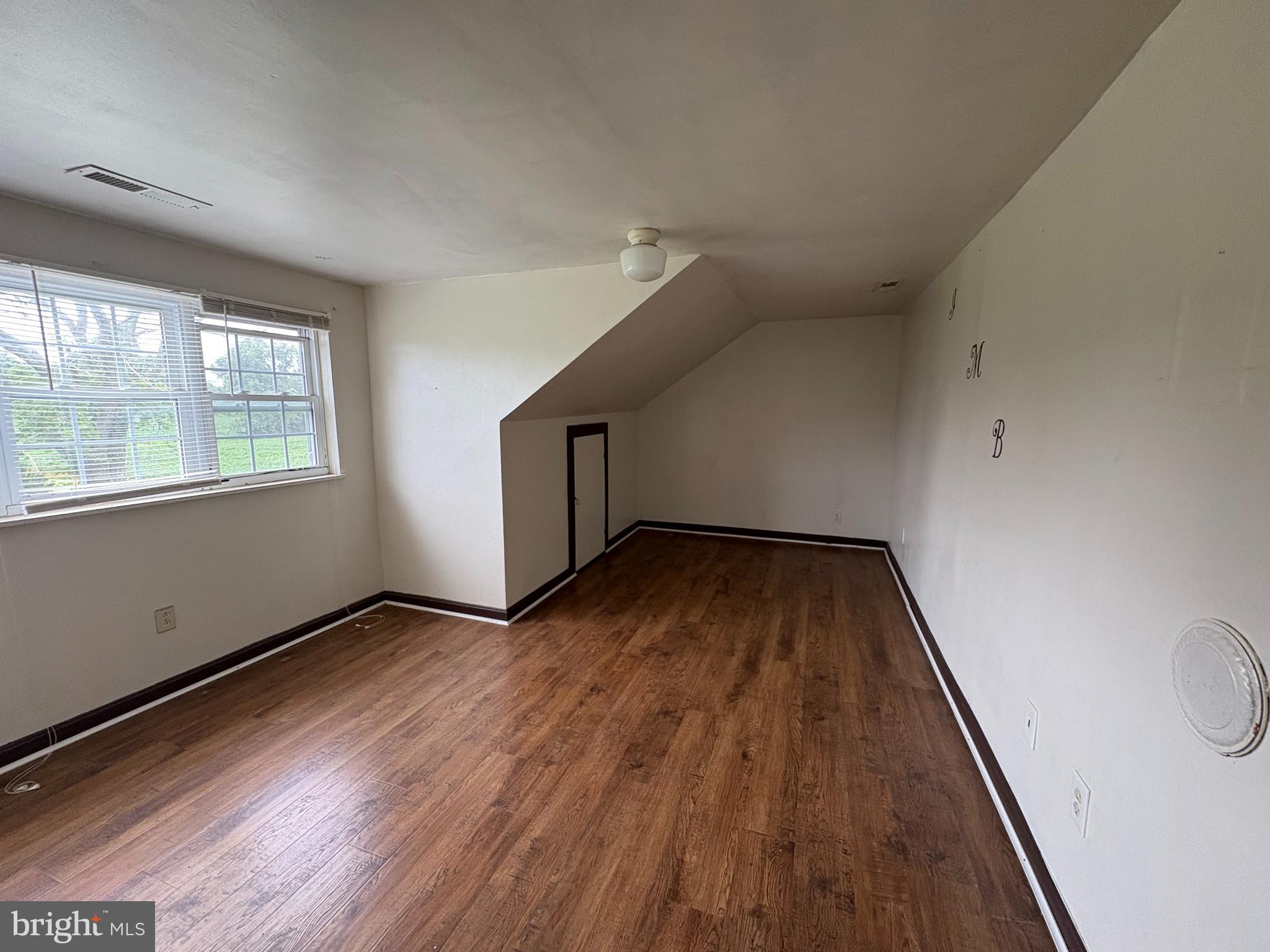 6525 Nomini Hall Road Hague, VA 22469 - Photo 29 of 44 wooden floor in an empty room with a window